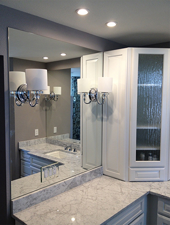 Mirrors over a vanity with mirrored outlet covers